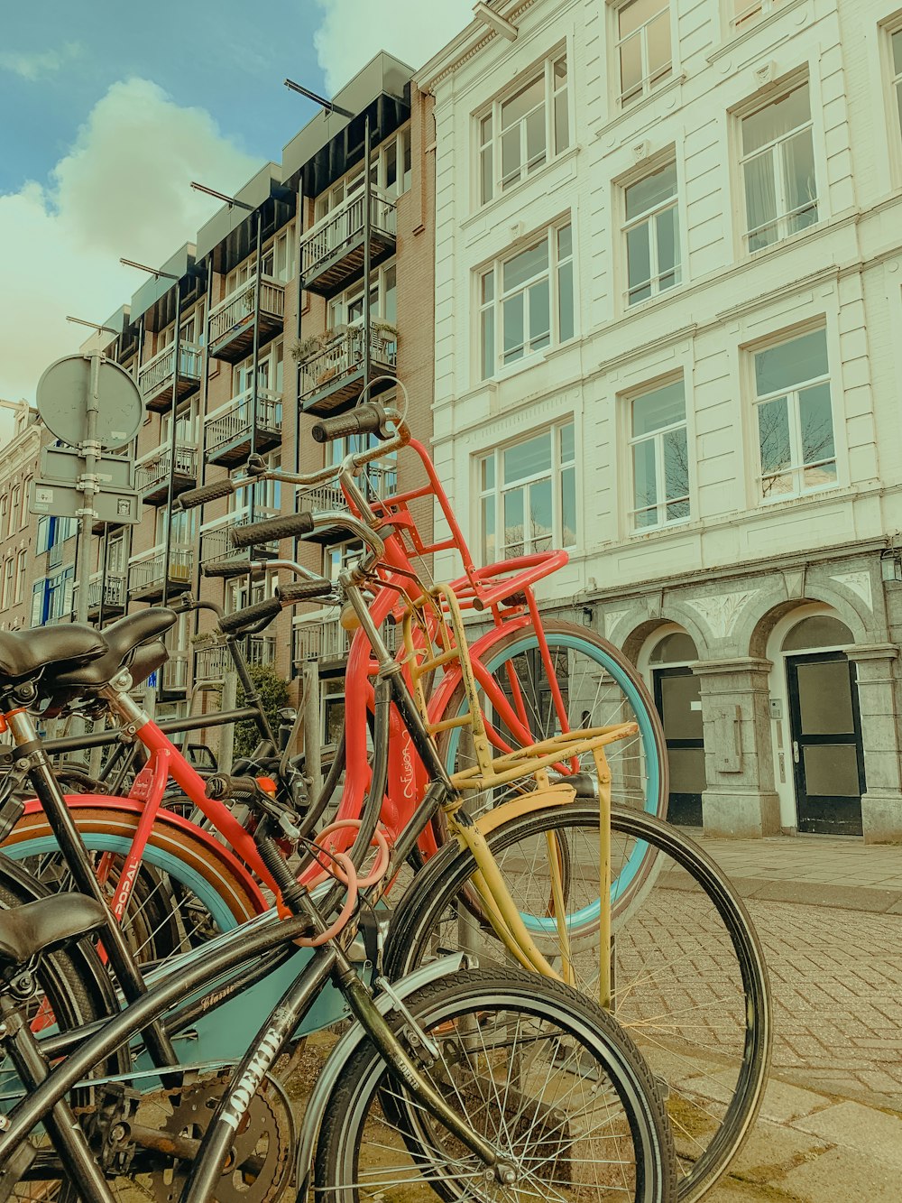 a group of bicycles parked on a sidewalk