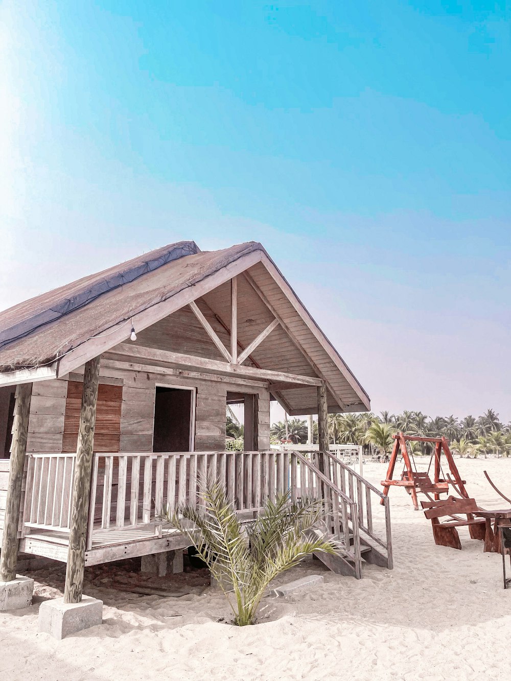 a wooden gazebo on a beach