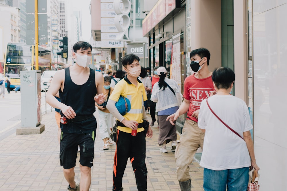 a group of people walking down a sidewalk