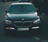 a black car parked on the side of a road