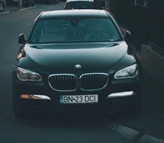a black car parked on the side of a road