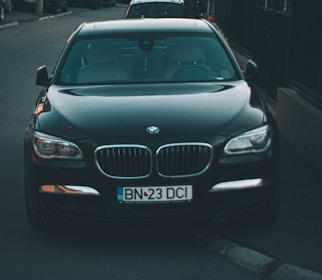 a black car parked on the side of a road