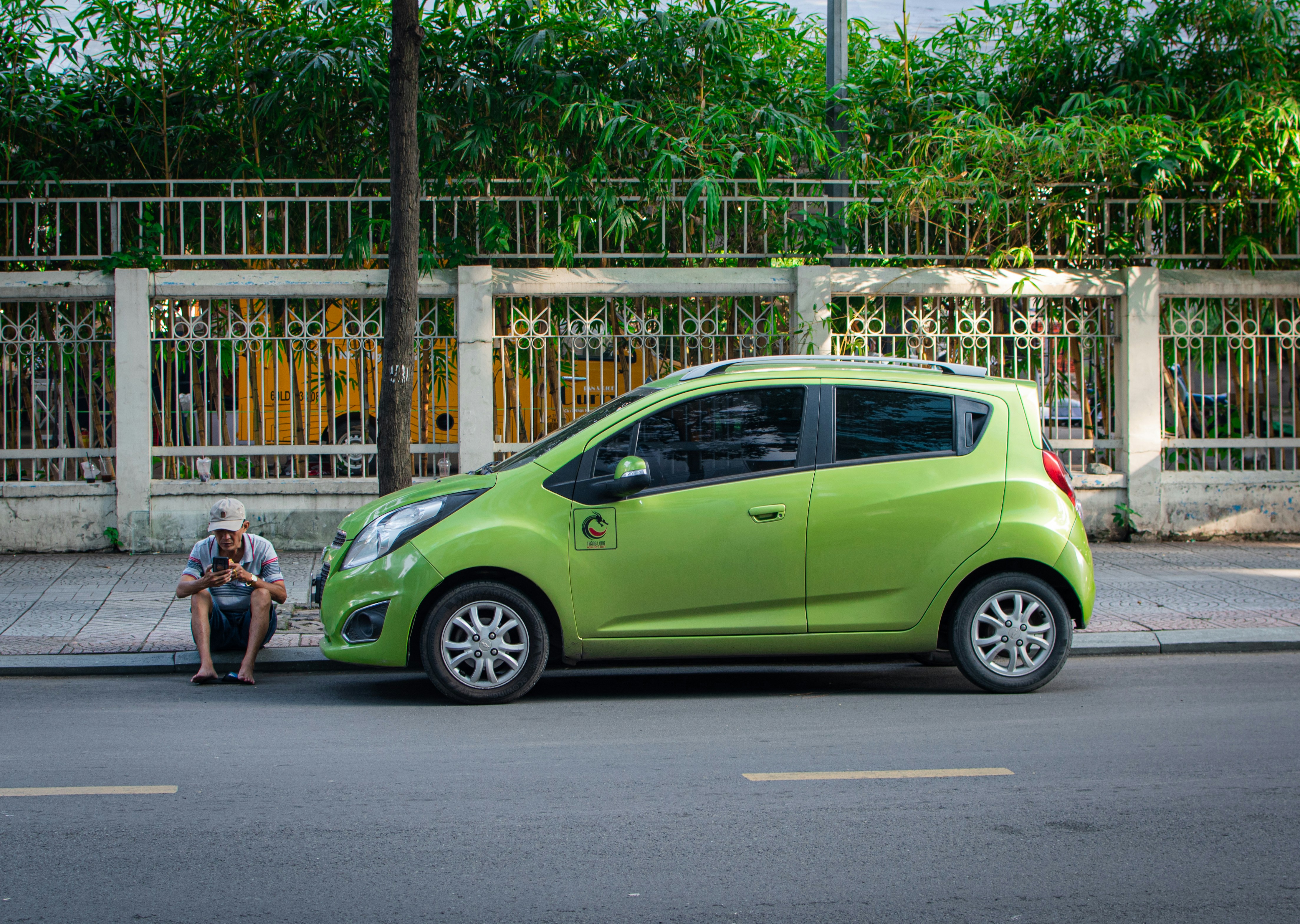 Family unloading groceries from an electric SUV while it charges in a home driveway
