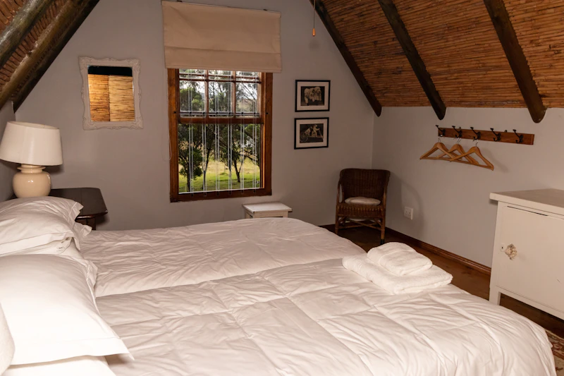 A bedroom with a bed and a chair