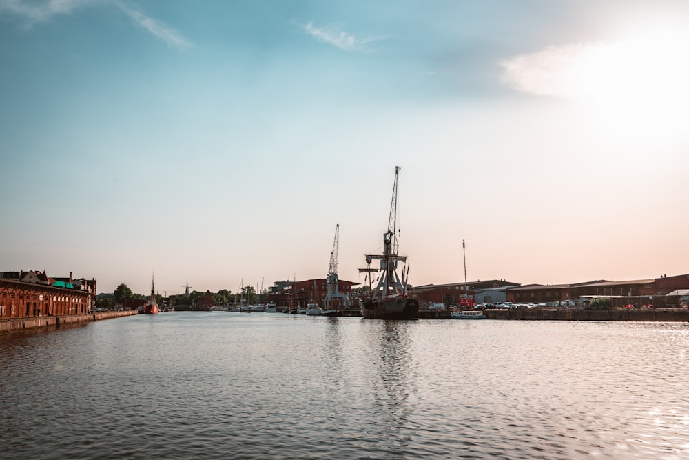 a body of water with buildings and a tower in the background