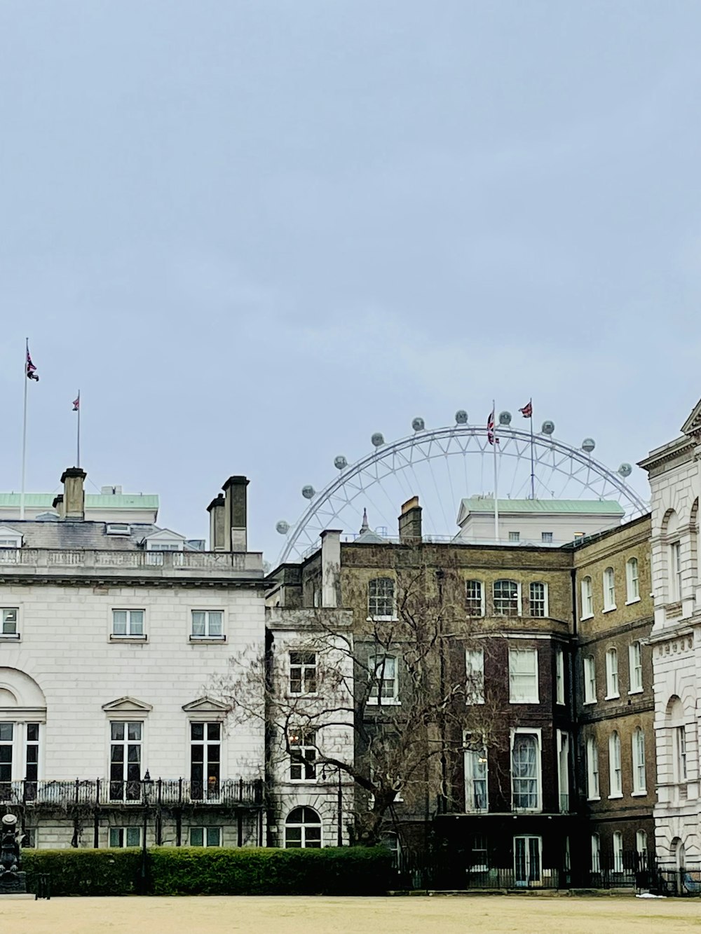 a large building with a ferris wheel in the background