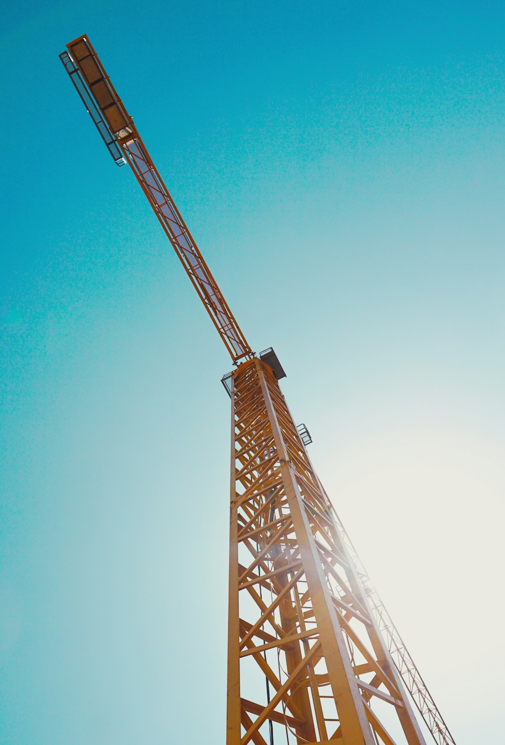 a tall crane with a blue sky