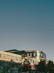 A modern commercial building under clear blue sky.