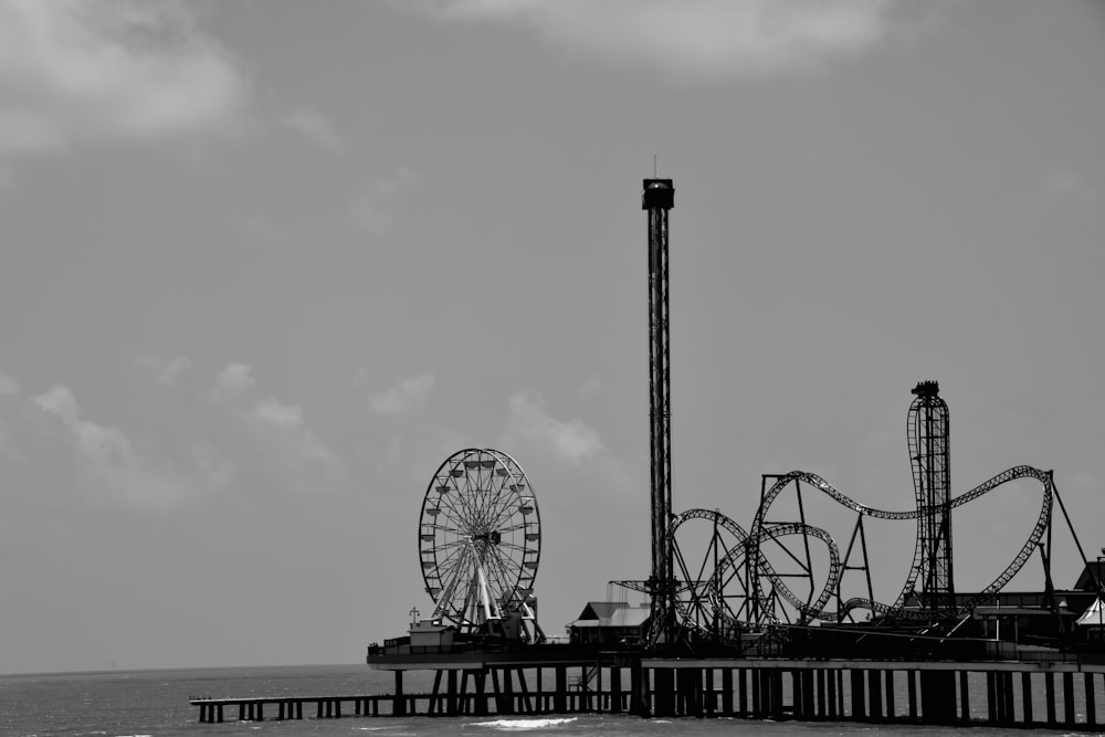 a ferris wheel next to a body of water