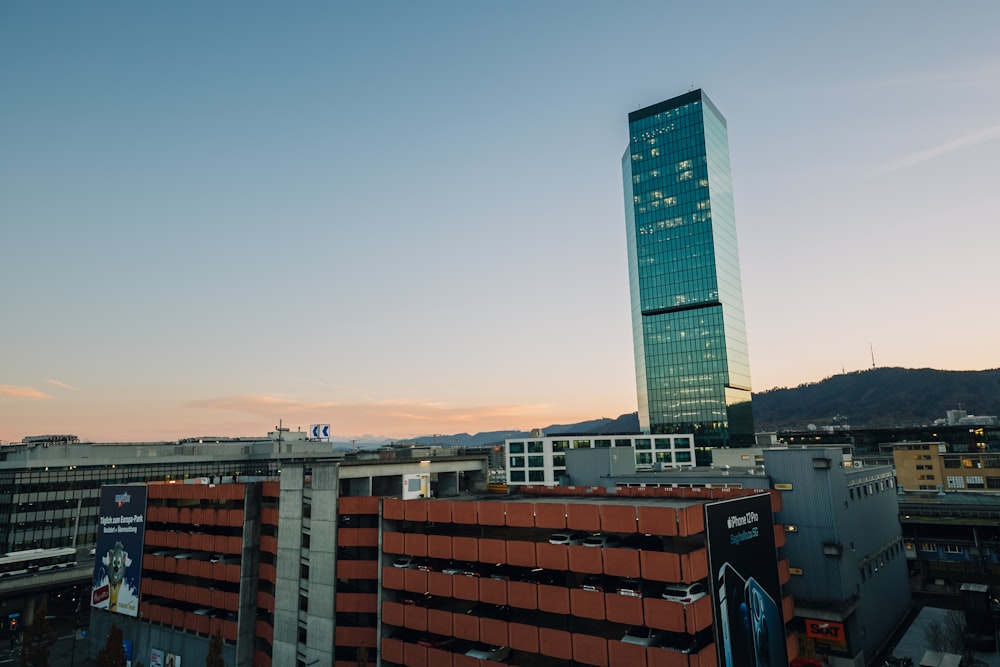 a tall building behind a group of buildings