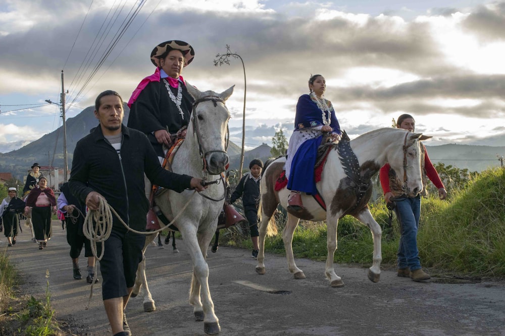 a group of people riding horses