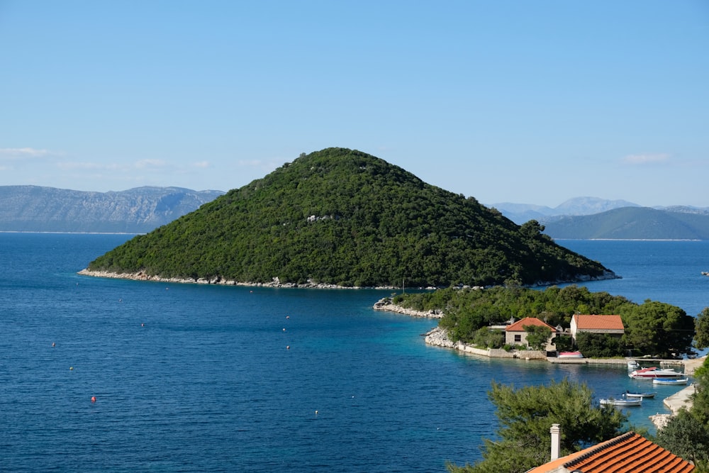 a body of water with a hill in the background