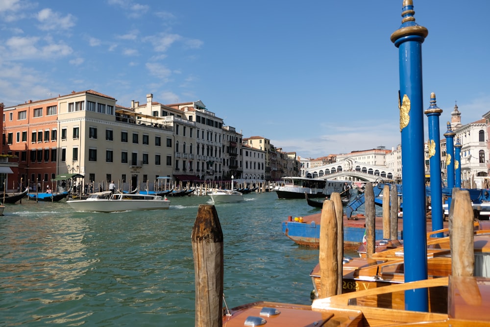 a body of water with boats in it and buildings around it with Grand Canal in the background