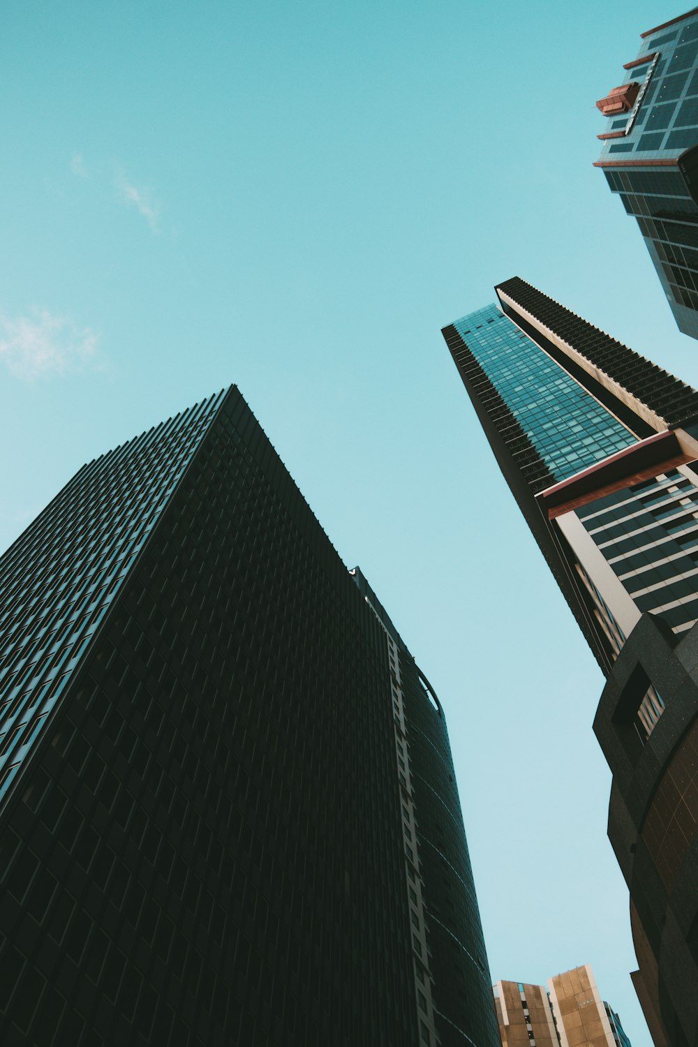 a few skyscrapers against a blue sky