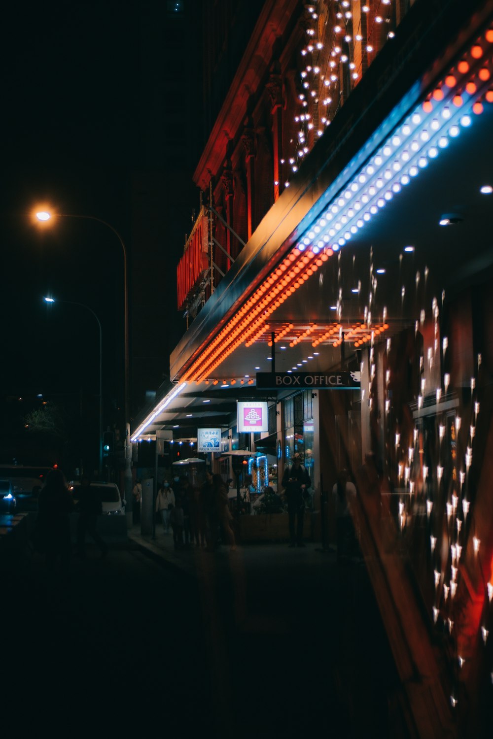 a street with a building with lights