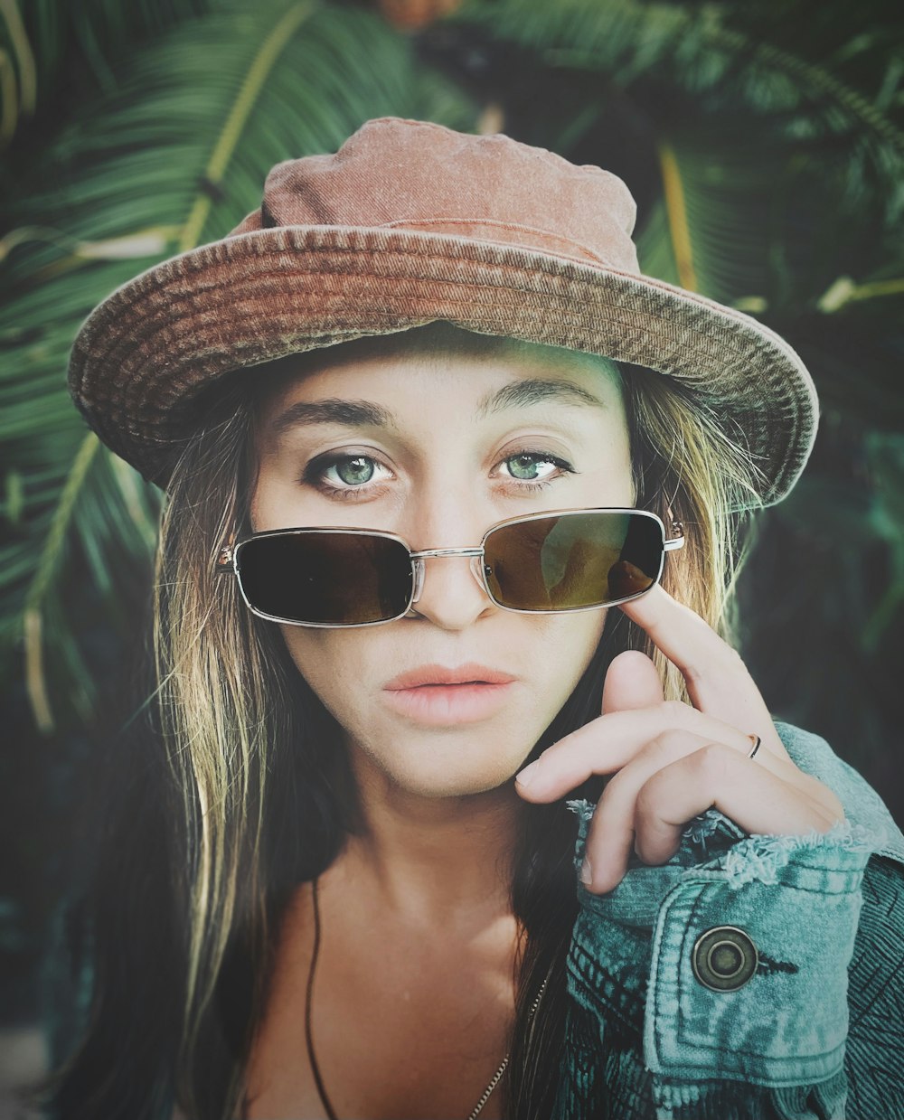 a woman wearing a hat and sunglasses