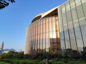 A completed modern residential building glowing warmly at sunset.