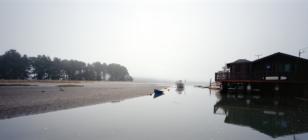 a body of water with boats in it and a building in the back