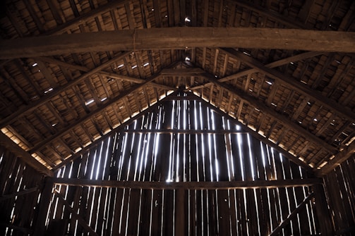 A rustic barn with sunlight streaming through, symbolizing the heart of our cattle farm.