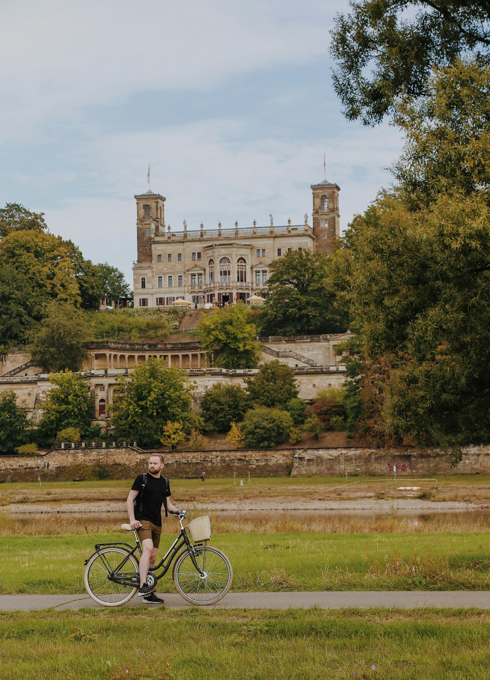 a person riding a bicycle on a path in a park