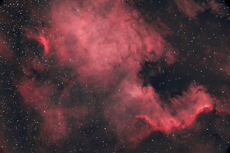 Close-up of a glowing teal and purple nebula swirling against a dark space background.