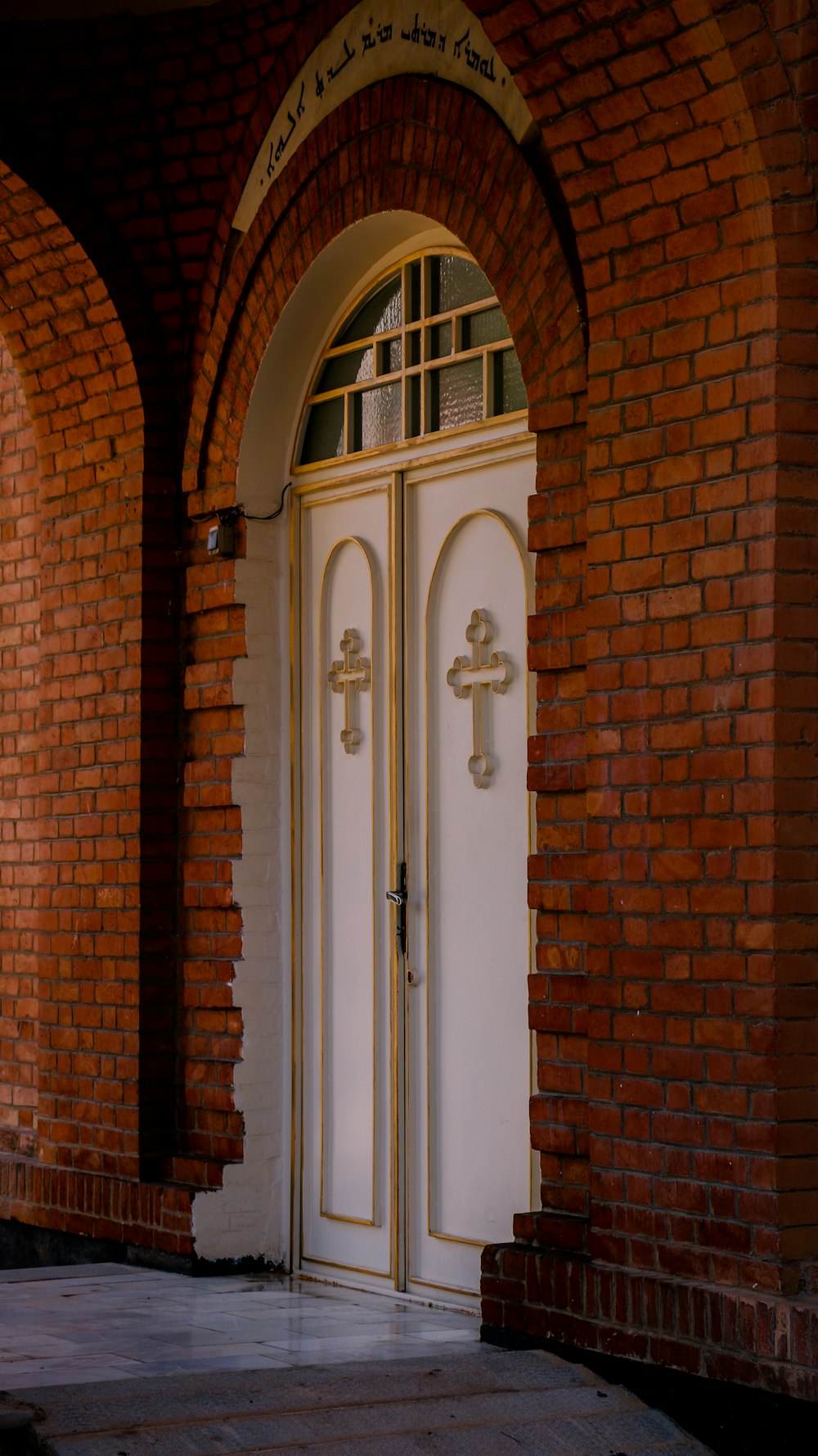 a white door in a brick building