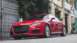 Red sports car with polished chrome details on a city street