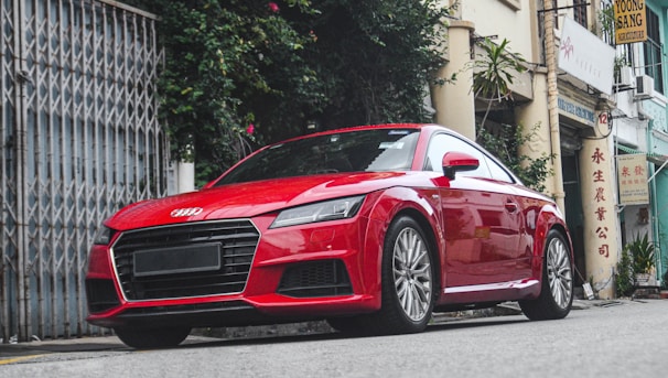 Red sports car with polished chrome details on a city street