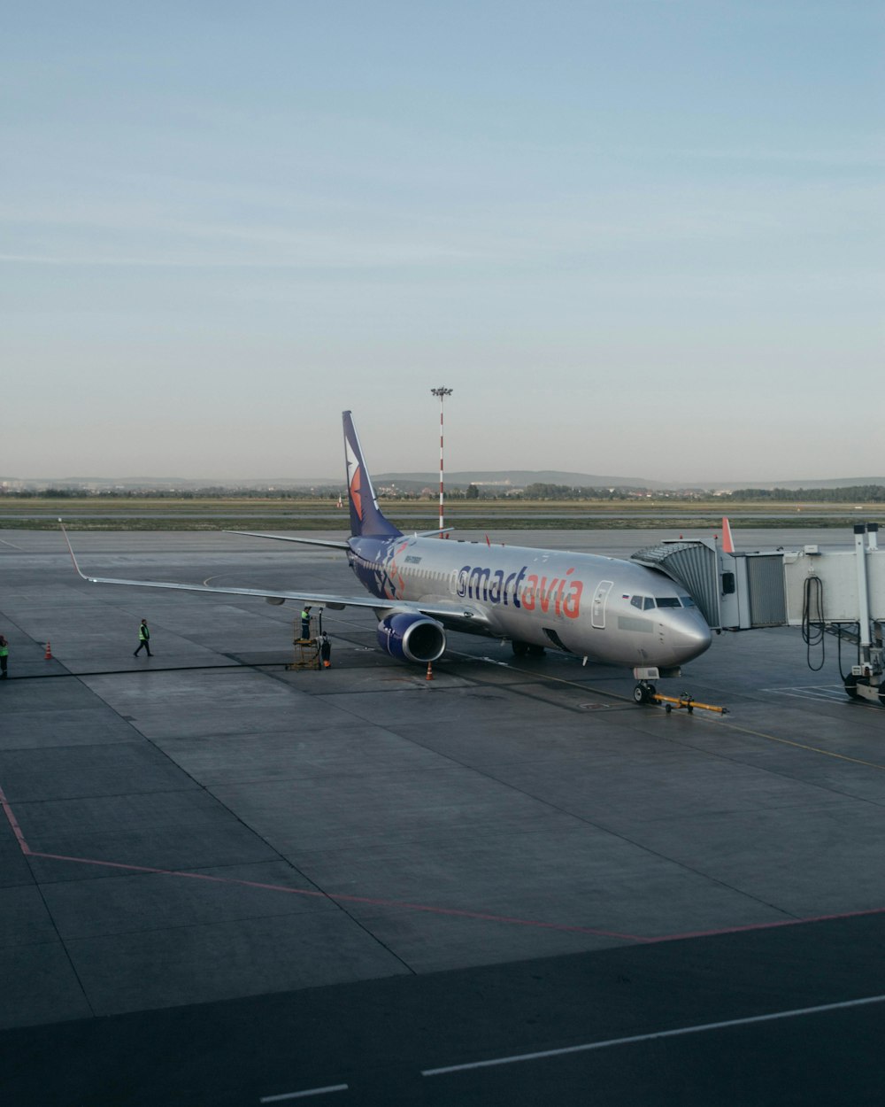 a large passenger jet sitting on top of a tarmac at an airport