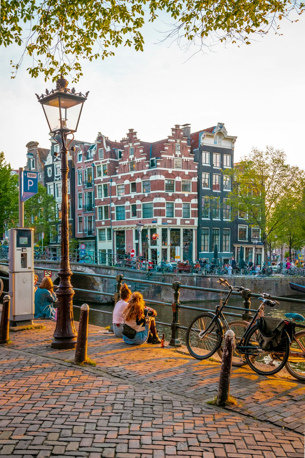 a group of people on a sidewalk next to a bicycle