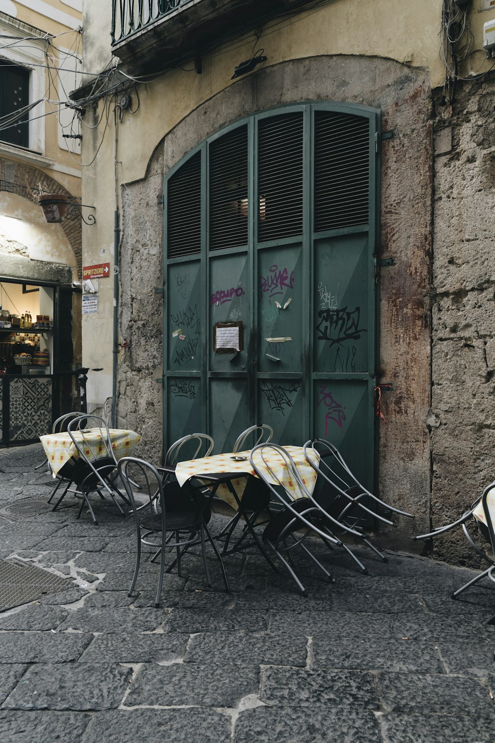 a table and chairs outside a building