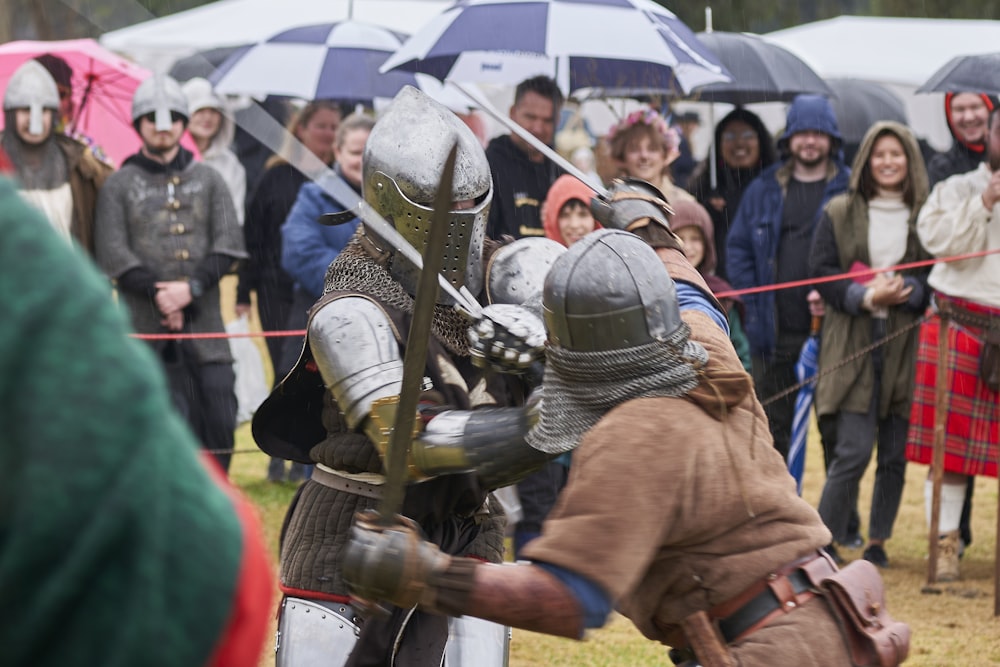 people in clothing holding shields