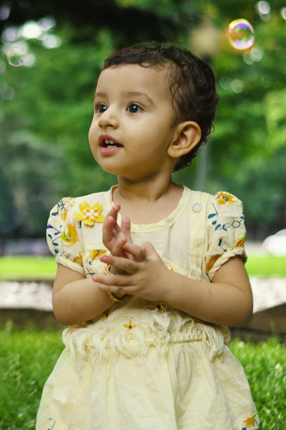 a baby in a yellow dress