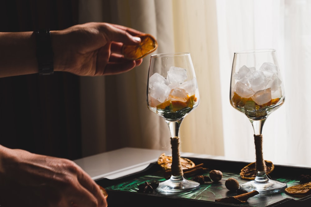 a hand pouring a drink into a glass