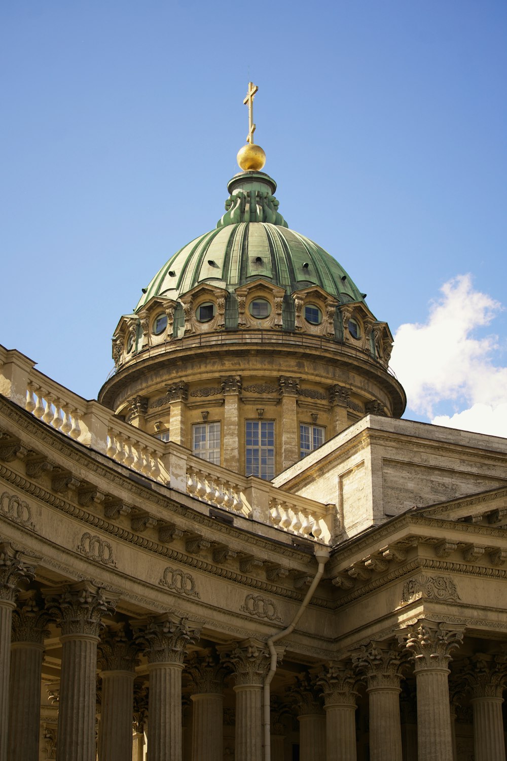 a building with a green dome and columns