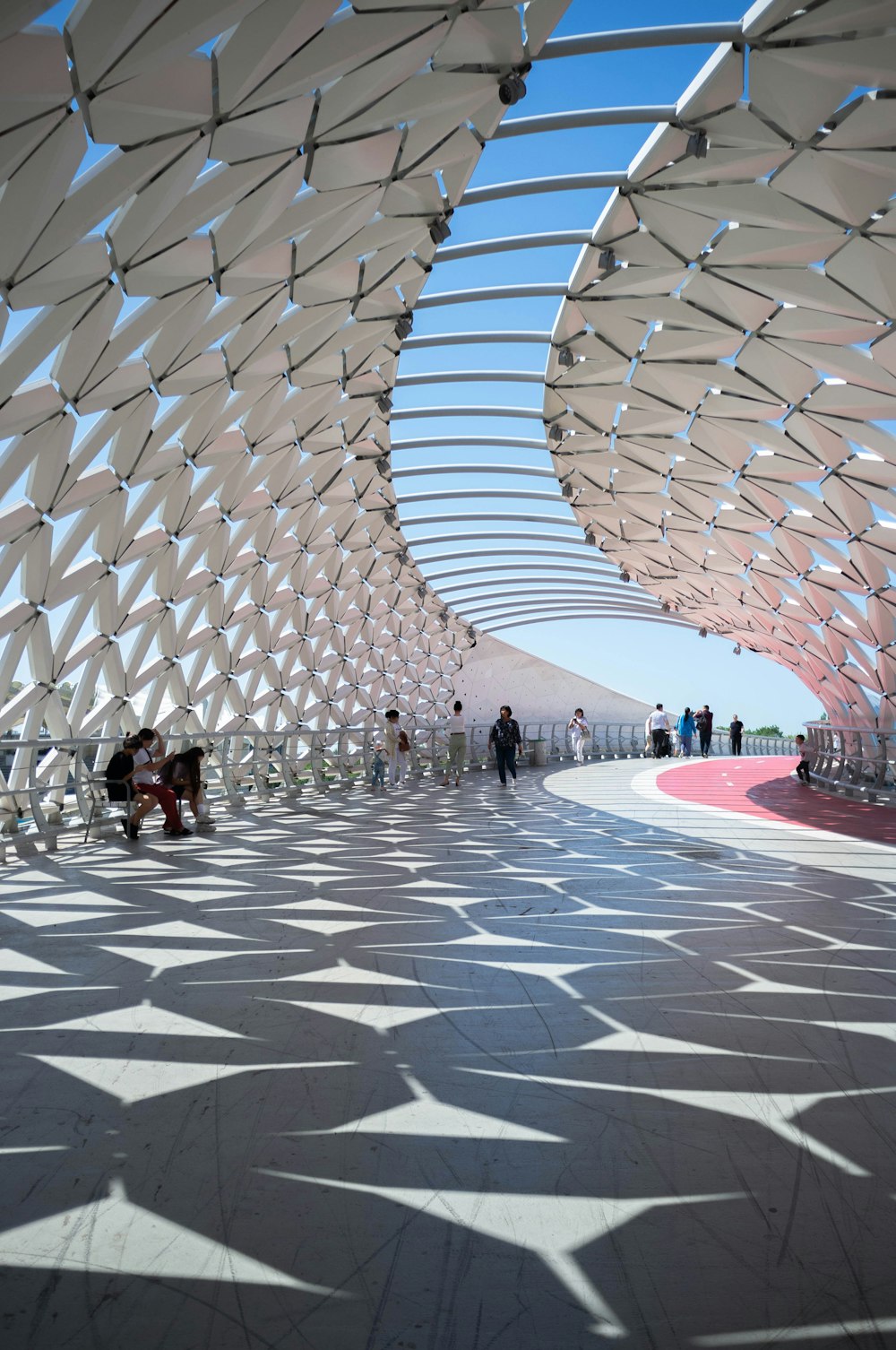 a large glass dome with people sitting on the ground