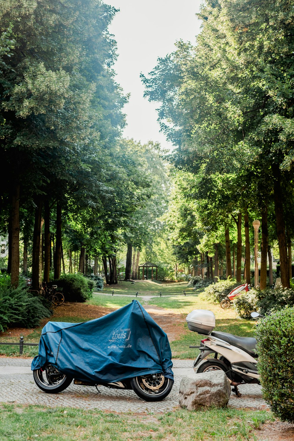 a blue tent next to a motorcycle