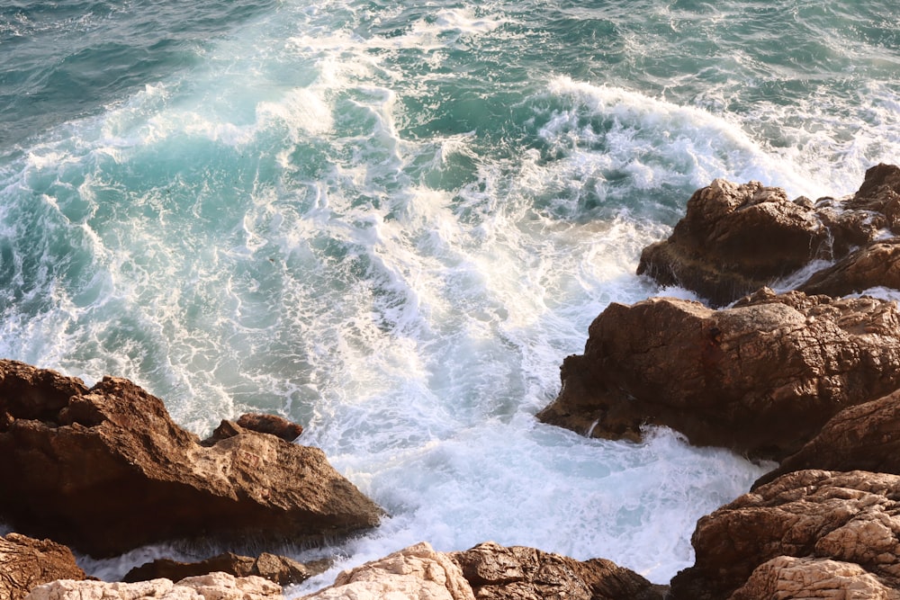 a rocky beach with waves crashing