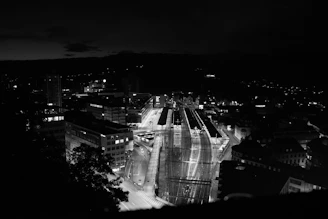 Exterior view of a cityscape of Quito at night with neon lights reflecting the station's vibe.