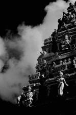 a large building with a large cloud of smoke behind it