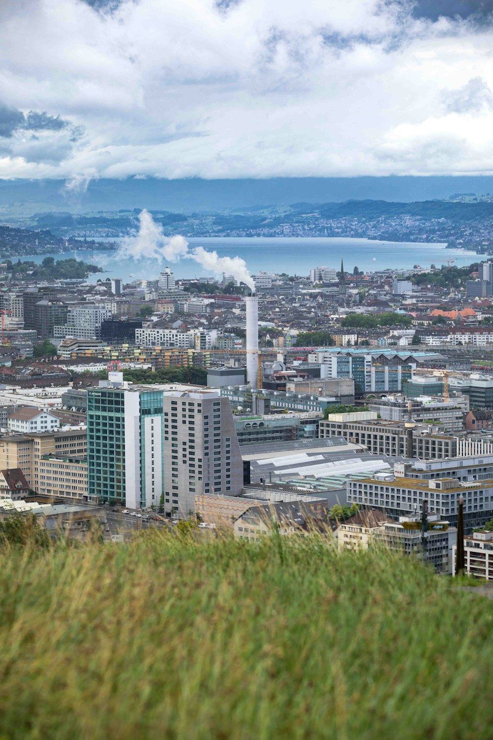 a city with a body of water in the background