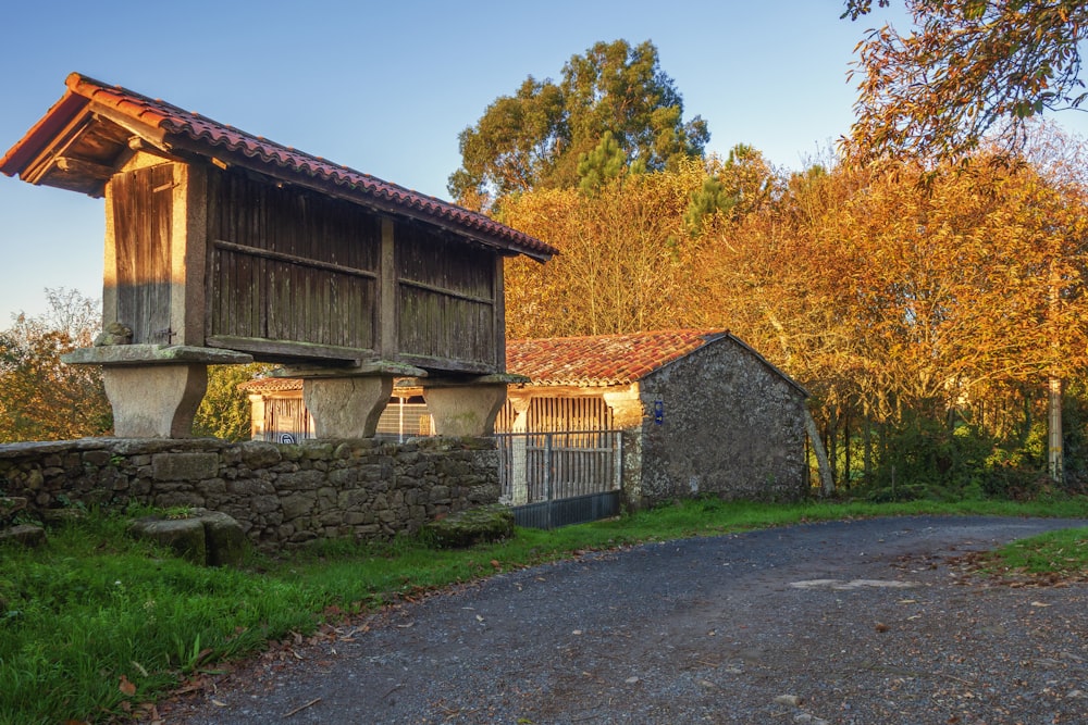 a stone building with a stone wall and a stone wall with trees