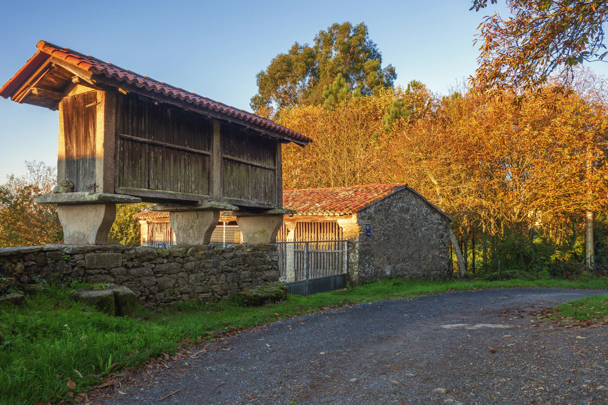 a stone building with a stone wall and a stone wall with trees