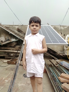 A young girl proudly presenting a solar-powered model she built as part of BIOSI Global’s educational outreach.