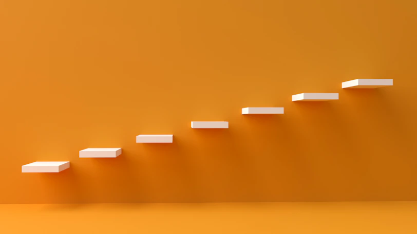 white steps rising on orange wall