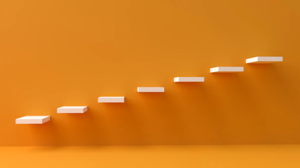 white steps rising on orange wall