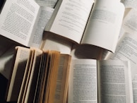 A variety of printed pages spread out showing different book layouts.