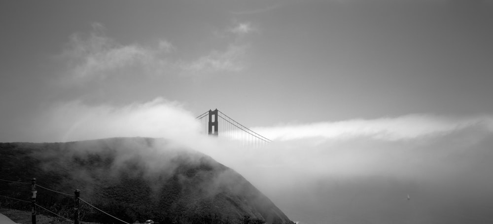 a bridge over a foggy mountain