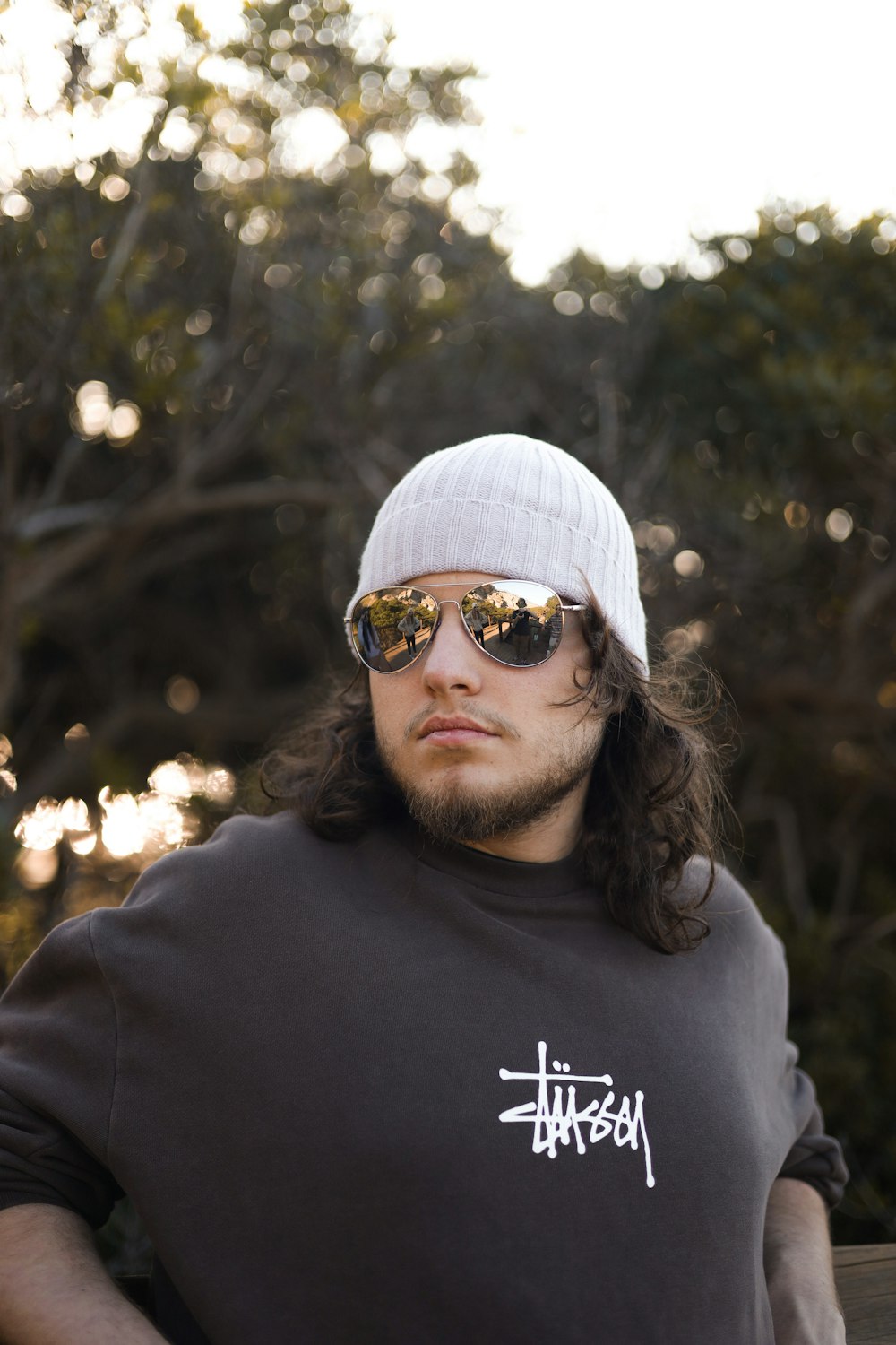 a man wearing sunglasses and a beanie