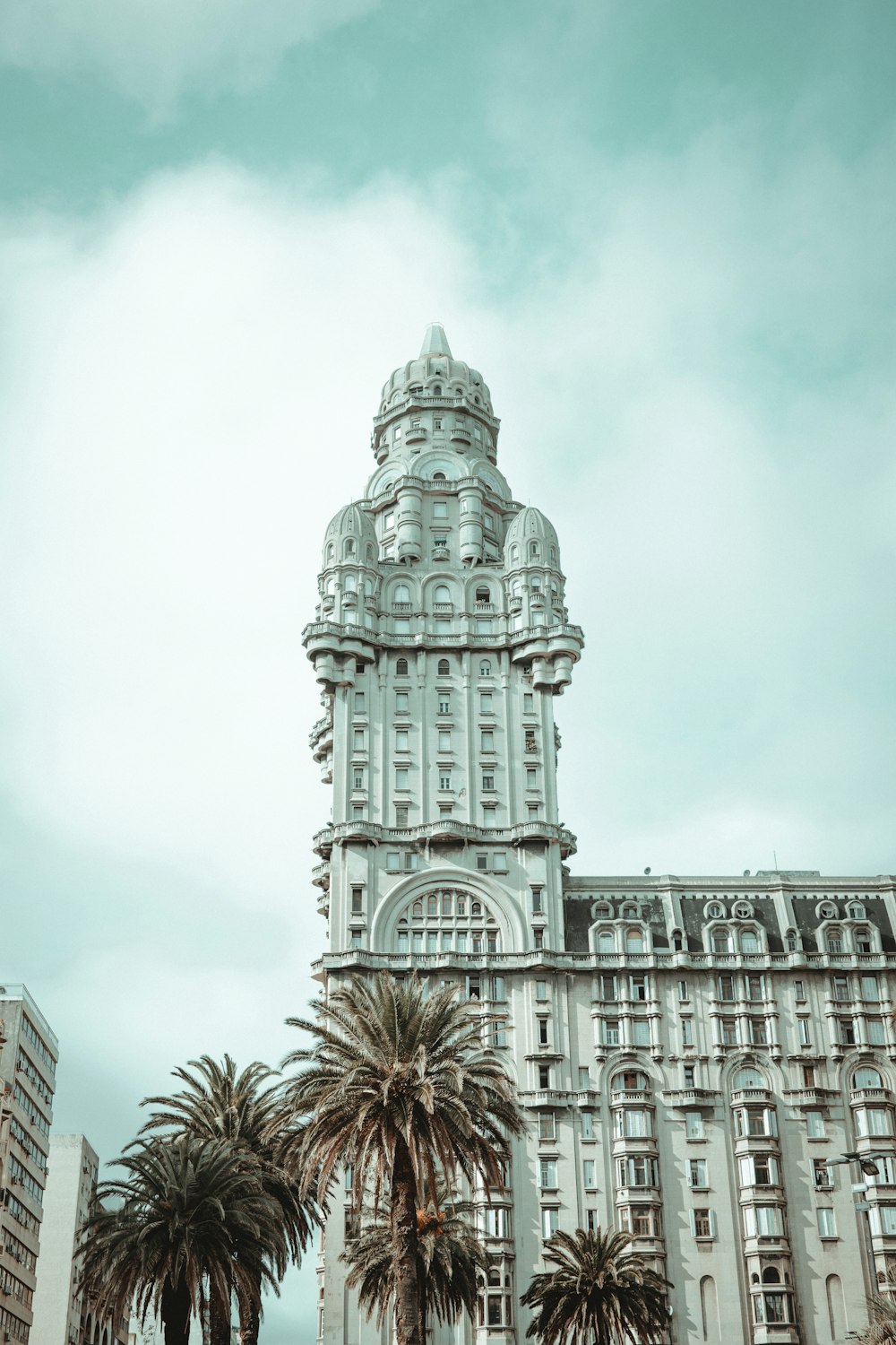 a tall building with palm trees